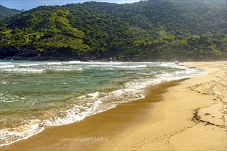 Hills and forest on the sand of Bonete beach on Ilhabela island in Sao Paulo, Bonete beach,