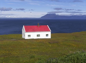 Lonely house with a red roof at Bakkafjordur in Iceland