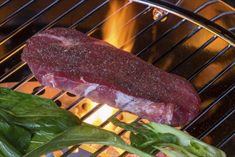 Steak with pak choi on the bbq