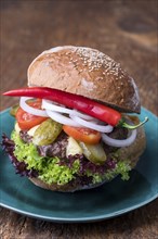 Cheeseburger on a blue plate with chili