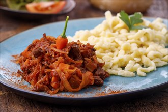 Szegedin goulash on dark wood