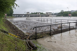 Symbolic image extreme weather, global warming, climate change, flood, washed up wood, footbridge,