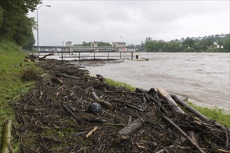 Symbolic image extreme weather, global warming, climate change, flood, washed up wood, barrage on