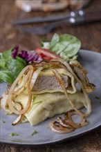 Swabian ravioli with onions on a plate