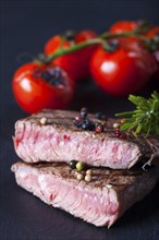 Juicy cut steak on a slate plate