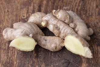 Fresh ginger on dark wood