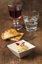 Greek hummus with wine on wood