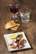 Greek octopus with wine on wood