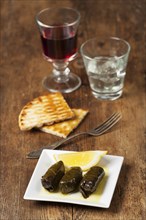 Greek dolmades with wine on wood