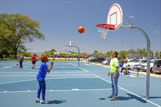 Detroit, Michigan, Rosie Randall, 85, competes in the Basketball Free Throw event at the Detroit