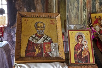 Two Christian icons in an old church setting. The pictures show saints in traditional orthodox