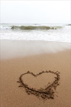 Heart as a drawing in the sand