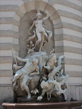 Baroque fountain statue with mythological figures on an exterior wall, Vienna, Austria, Europe