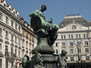 A bronze statue in an urban environment in front of historic buildings, Vienna, Austria, Europe