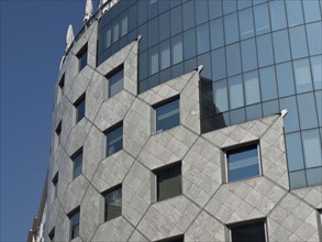 A modern building with a façade of glass windows and geometric patterns, Vienna, Austria, Europe