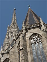 A gothic building with large windows and a high tower, clear blue sky, Vienna, Austria, Europe