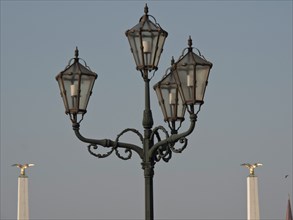 Classic street lamp with four lights and decorative elements against a clear sky, Vienna, Austria,