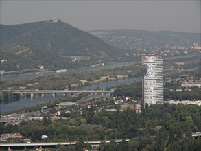 City panorama with modern skyscraper and several rivers crossing the landscape, Vienna, Austria,