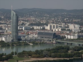 City panorama with skyscraper, bridge and river and surrounding mountain landscape, Vienna,