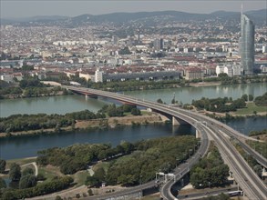 Urban panorama with river, bridge, skyscraper and surrounding landscape, Vienna, Austria, Europe