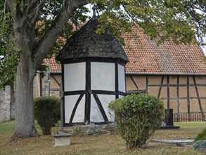 Small half-timbered house in a garden surrounded by trees in autumn, Waldeck, Hesse, Germany,