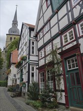 Half-timbered houses near a church tower, Werl, North Rhine-Westphalia, Germany, Europe