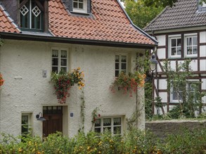 Half-timbered house with flowers on the windows and a red roof, Werl, North Rhine-Westphalia,