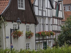 Half-timbered house with flowers on the windows and lamp on the street, Werl, North