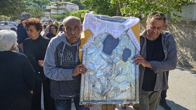 Men carrying a religious icon during a solemn procession, Procession of the icon of Panagia Skiadni