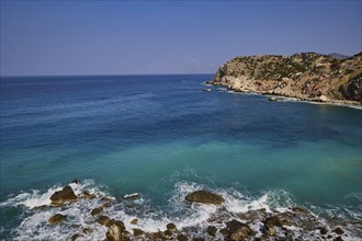 Wide coastal landscape with cliffs and blue sea in the background, Atavyros beach, near Monolithos