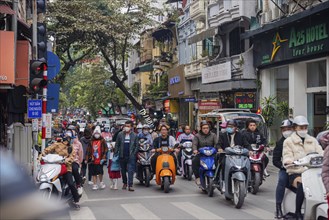 Vietnam Hanoi street scene with many scooters