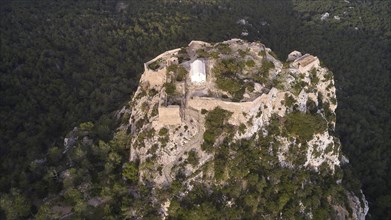 An old fortress on a wooded hill, taken from the air, Kastro Monolithou, Monolithos Castle, rock