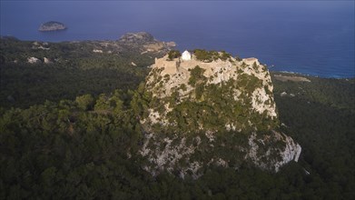 Aerial view of a castle on a wooded hill at dusk, Kastro Monolithou, castle Monolithos, rock