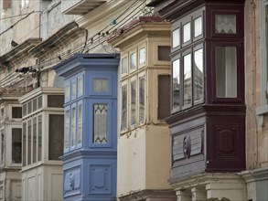Colourful wooden balconies adorn historic buildings in an old town, valetta, mediterranean sea,