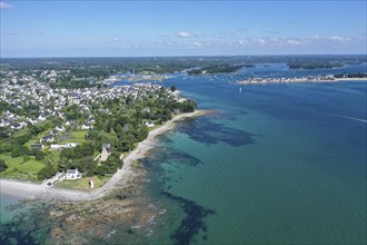 Aerial view of the coast of Loctudy with villas and lighthouse Phare de Langoz, behind Ile-Tudy,