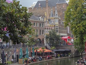 Cosy terraces on the canal surrounded by historic buildings and lively city life, utrecht,