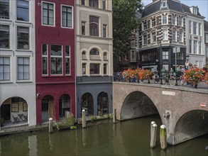 City view with a bridge over a canal, many flowers and multi-storey buildings, utrecht, Netherlands