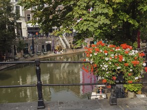 Kanaal with adjoining cafés and lively floral decorations, a relaxed and lively atmosphere,