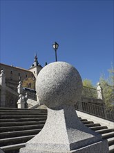 Stone steps leading up to a castle, flanked by lanterns and a stone sphere, Toledo, Spain, Europe
