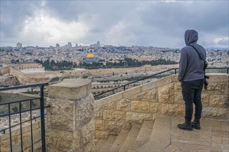 Young Israeli with machine gun overlooking Jerusalem Old City from Mount of Olives