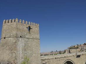 Historic watchtower and stone fortress with clear blue sky, Toledo, Spain, Europe