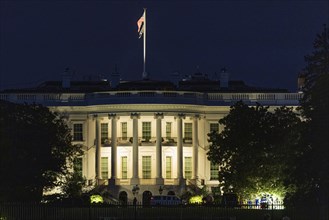 South lawn view of the White House, presidential residence at night illuminated
