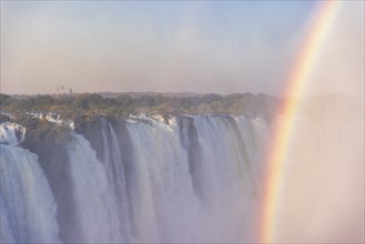 Close-up of the victoria falls in Zimbabwe, on a late afternoon with rainbow