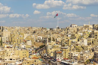 Jordan flag in Amman, panorama view of cloudy sky