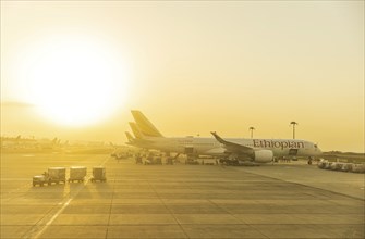 Sunset behind Ethiopian Airlines airplanes at Addis Ababa Bole International Airport ADD