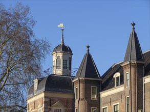 Castle towers and roof with weather vane on a sunny day, ruurlo, gelderland, netherlands
