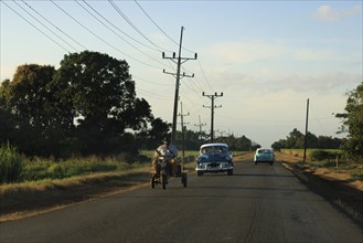 Cuban Highway Scene with old cars and electric wires