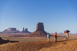 Familly in Monument Valley Tribal Park with colorful umbrella