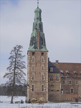 Close-up of a castle with a high tower, in the background a winter day with blue sky, Raesfeld,