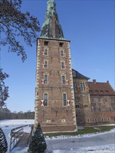 High castle tower in winter, covered with snow, in sunny weather, impressive historical